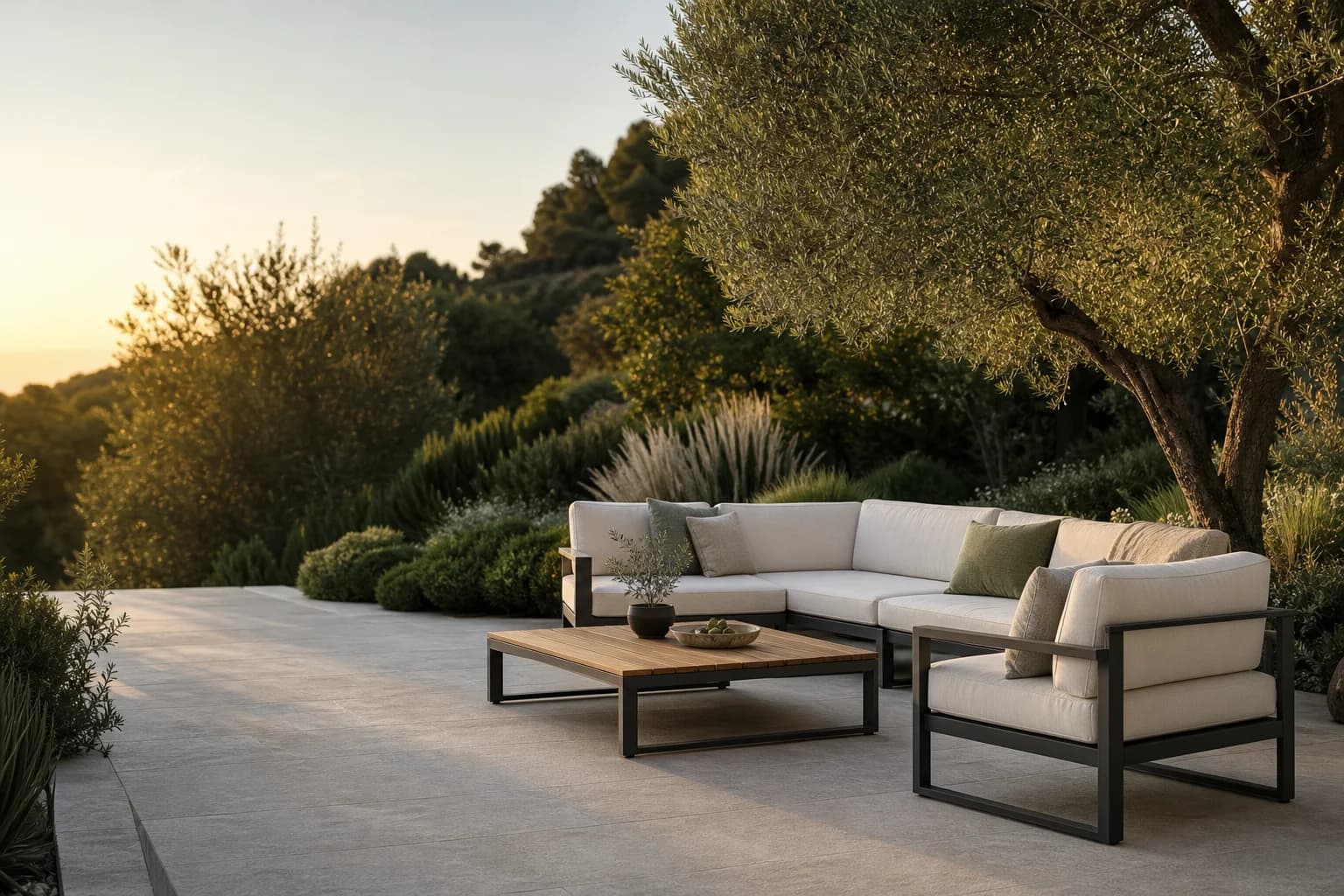 Modern lounge set on a garden terrace surrounded by planting